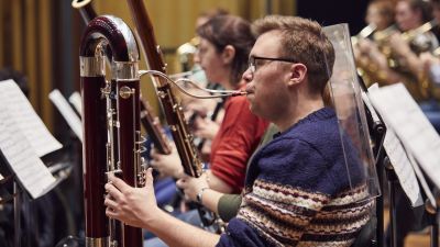 Bassoon player in an orchestal rehearsal in Silk Street Music Hall